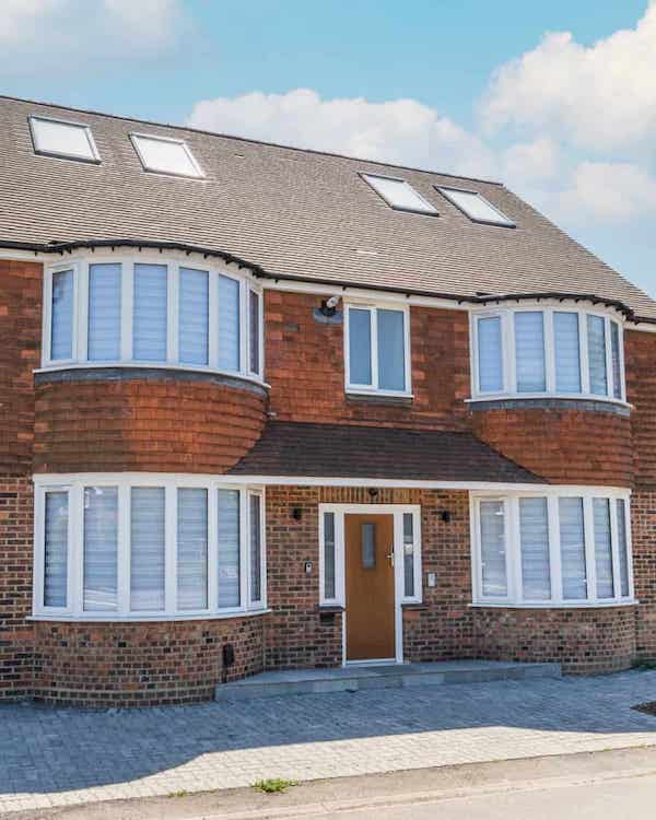 A house with bay windows on the ground and first floor levels, either side of a central front door.